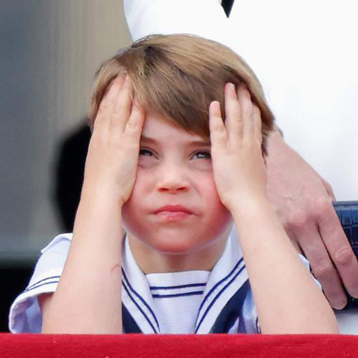 Louis rested his head on his hands whilst on the palace balcony.