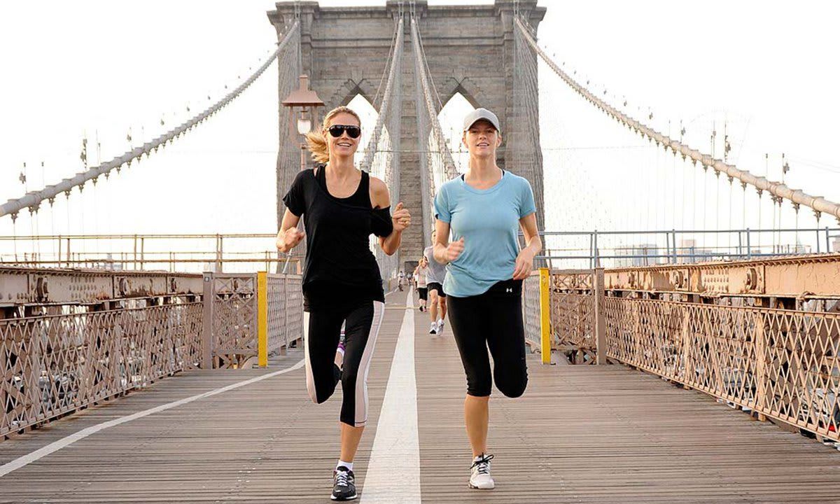 Women running across the Brooklyn Bridge