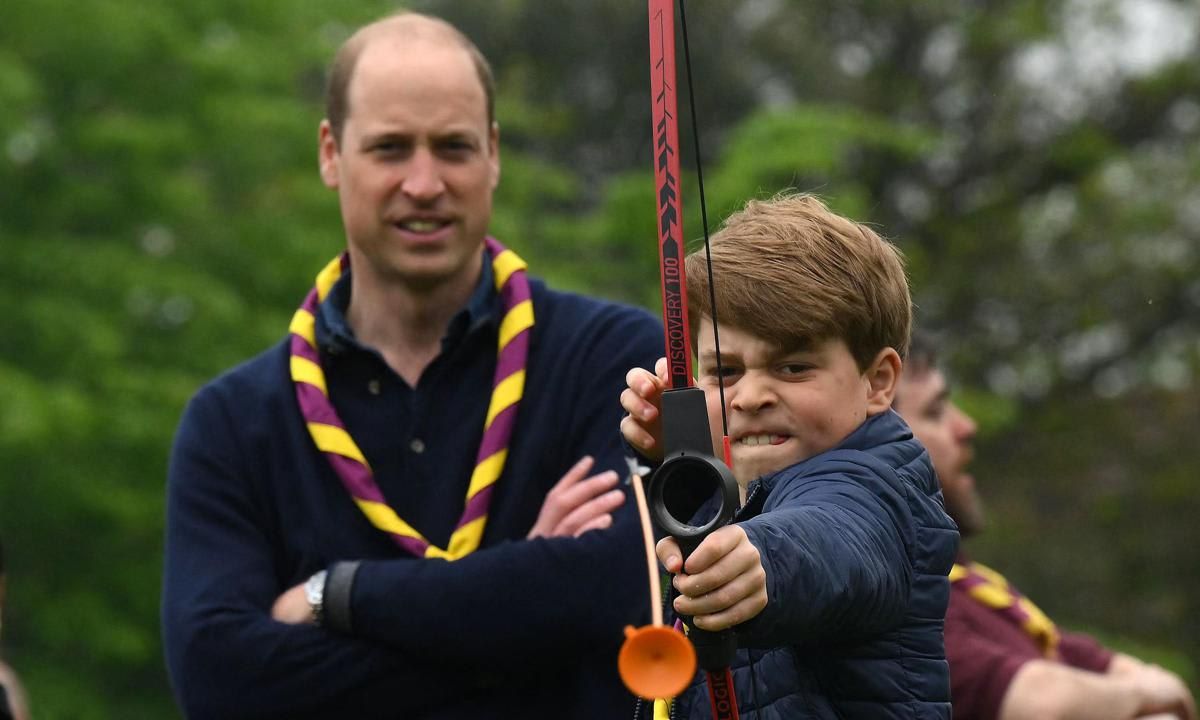 Prince George tried his hand at archery while volunteering with his family at Upton Scouts Hut in Slough.
