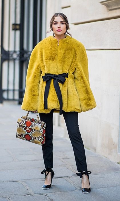 Olivia Culpo made a statement with a faux fur coat and graphic bag in the streets of Paris on February 28.
Photo: Timur Emek/Getty Images