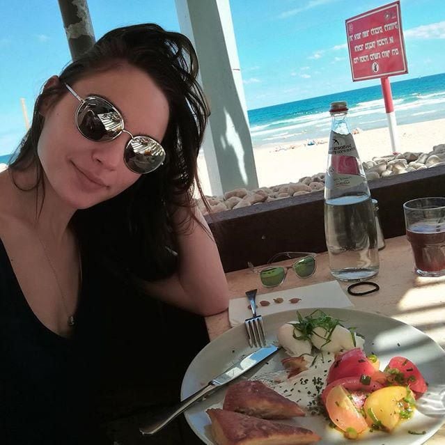 Gal Gadot eating at the beach