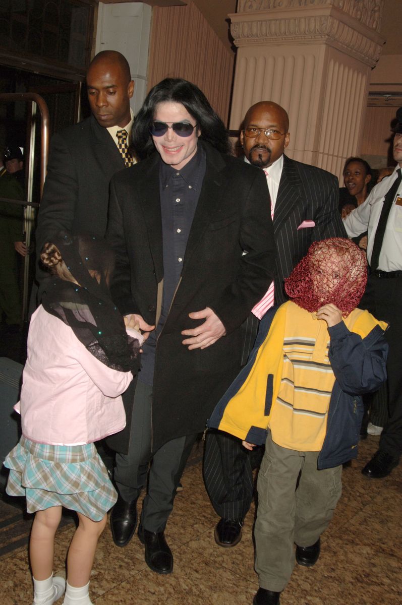 Singer Michael Jackson (C) walks with his children, Prince and Paris, as they visit Harrods on October 12, 2005, in London, England.  (Photo by Dave M. Benett/Getty Images)