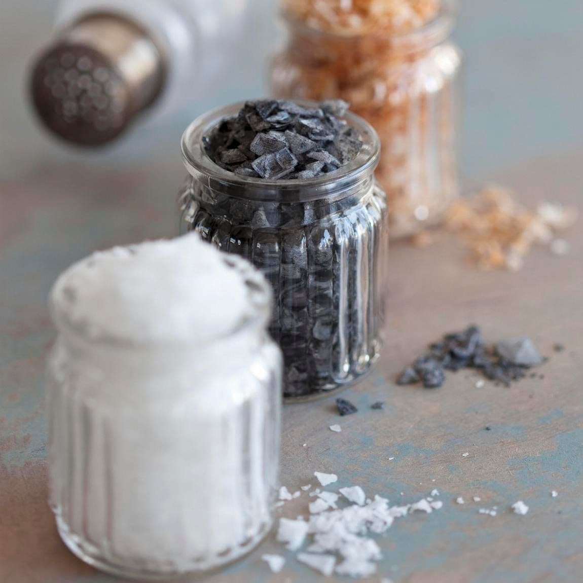 Black salt, paprika salt and sea salt flakes in glasses