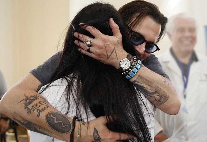 Johnny Depp hugs a woman