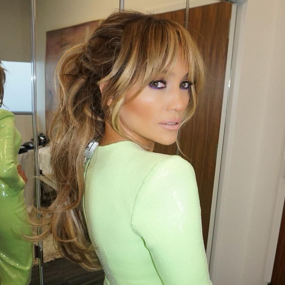 Jennifer Lopez with bangs and long wavy hair 