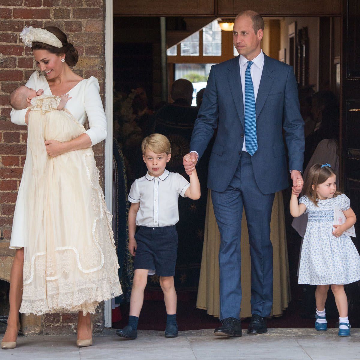 Doting mom Kate sweetly held her youngest son, while William strolled with George and Charlotte following Prince Louis' christening in 2018.