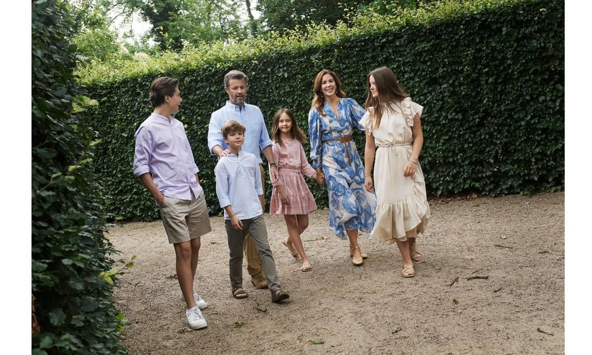 Dressed in summer attire, the royal family of six strolled through a garden together.