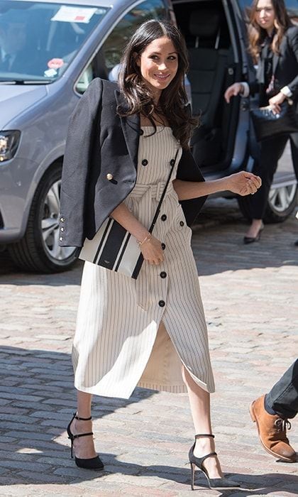 On April 18, Meghan who is definitely our new favorite queen of neutrals! joined her husband-to-be Prince Harry in London to attend the Commonwealth Youth Forum meeting for the Commonwealth Heads of Government Meeting (CHOGM). The 36-year-old future royal bride sported a nautical look that was perfect for the sunny weather: a pinstriped cream button-front dress by Altuzarra, a Camilla and Marc blazer and, <a href="https://us.hellomagazine.com/fashion/12018032826440/meghan-markle-purse-top-handle-handbag/1/"><strong>leaving her top-handle handbags at home</strong></a>, the $221 graphic striped Avalon crossbody purse by Australian luxury brand Oroton.
Photo: Getty Images