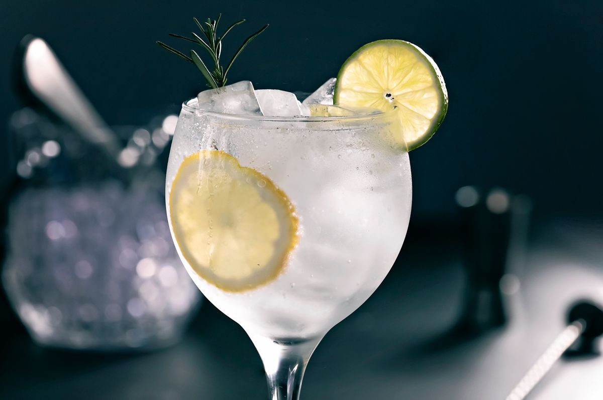 Close up of gin and tonic cocktail on black background