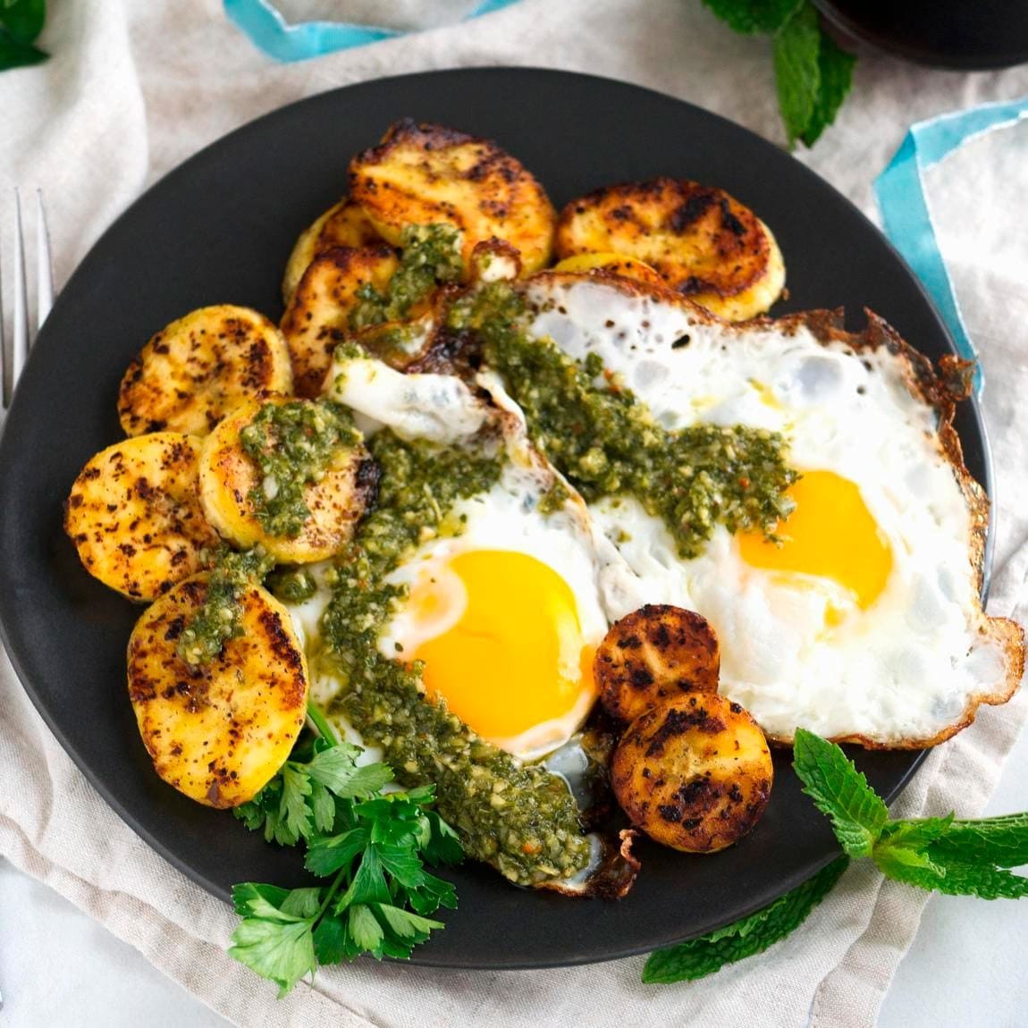 Fried eggs with plantain and chimichurri sauce for breakfast