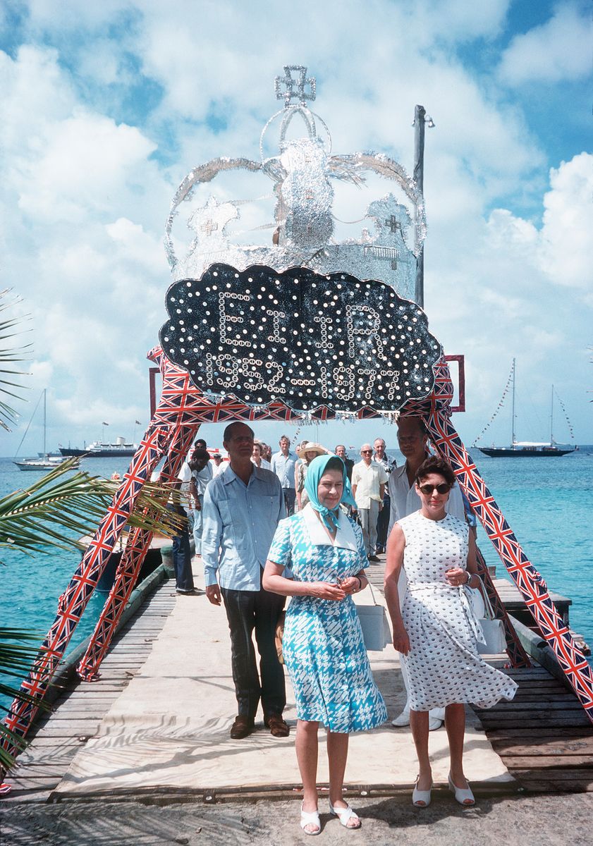 Queen Elizabeth II arrives in Mustique, Saint Vincent and is welcomed by Princess Margaret in 1977.
