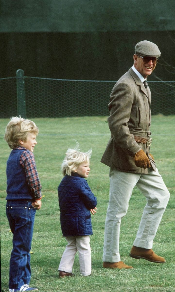 Following the leader! The Queen's husband was dressed to the nines as he strolled the grounds of the 1984 Royal Windsor Horse Show with Peter and Zara Phillips behind him.