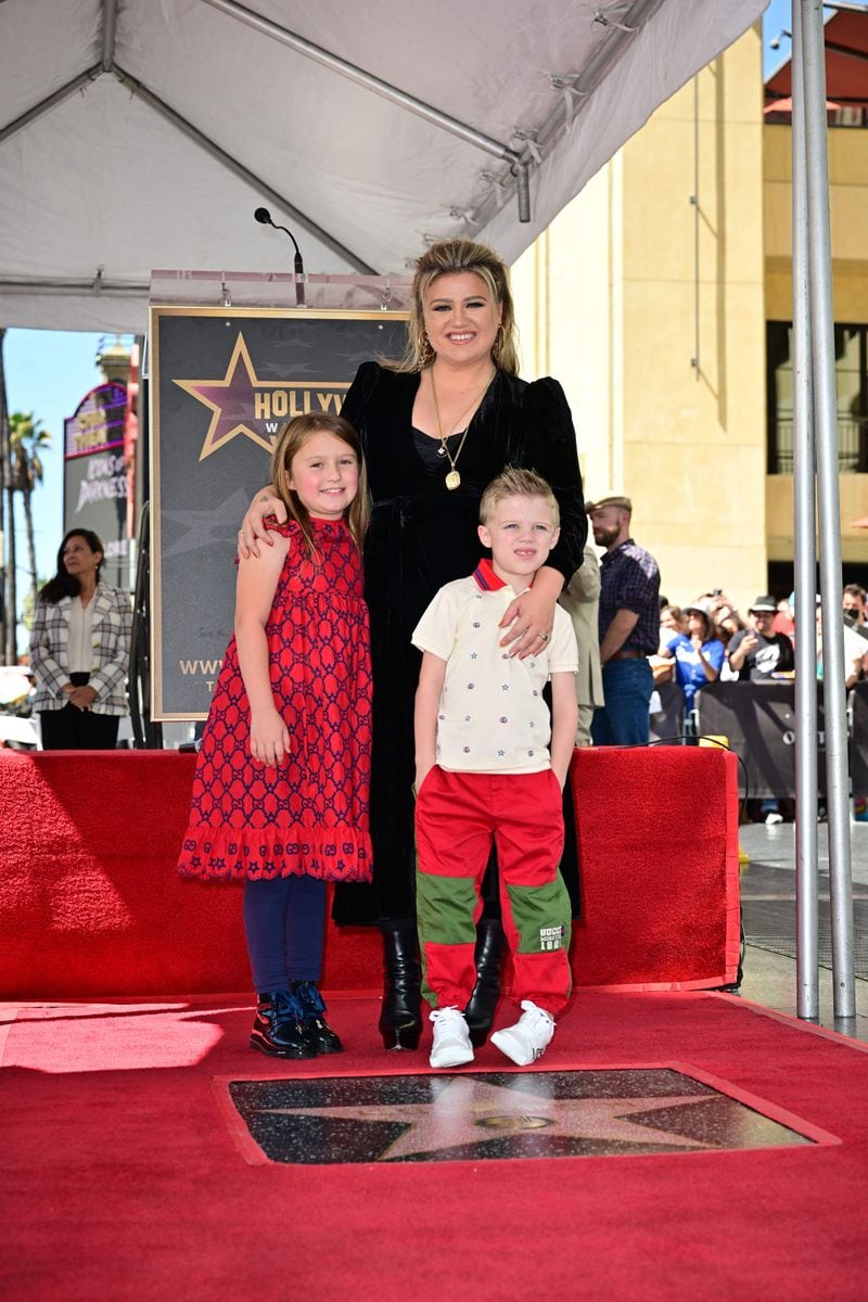 Kelly Clarkson, joined by her children, stands for a photo with her newly unveiled Hollywood Walk of Fame Star