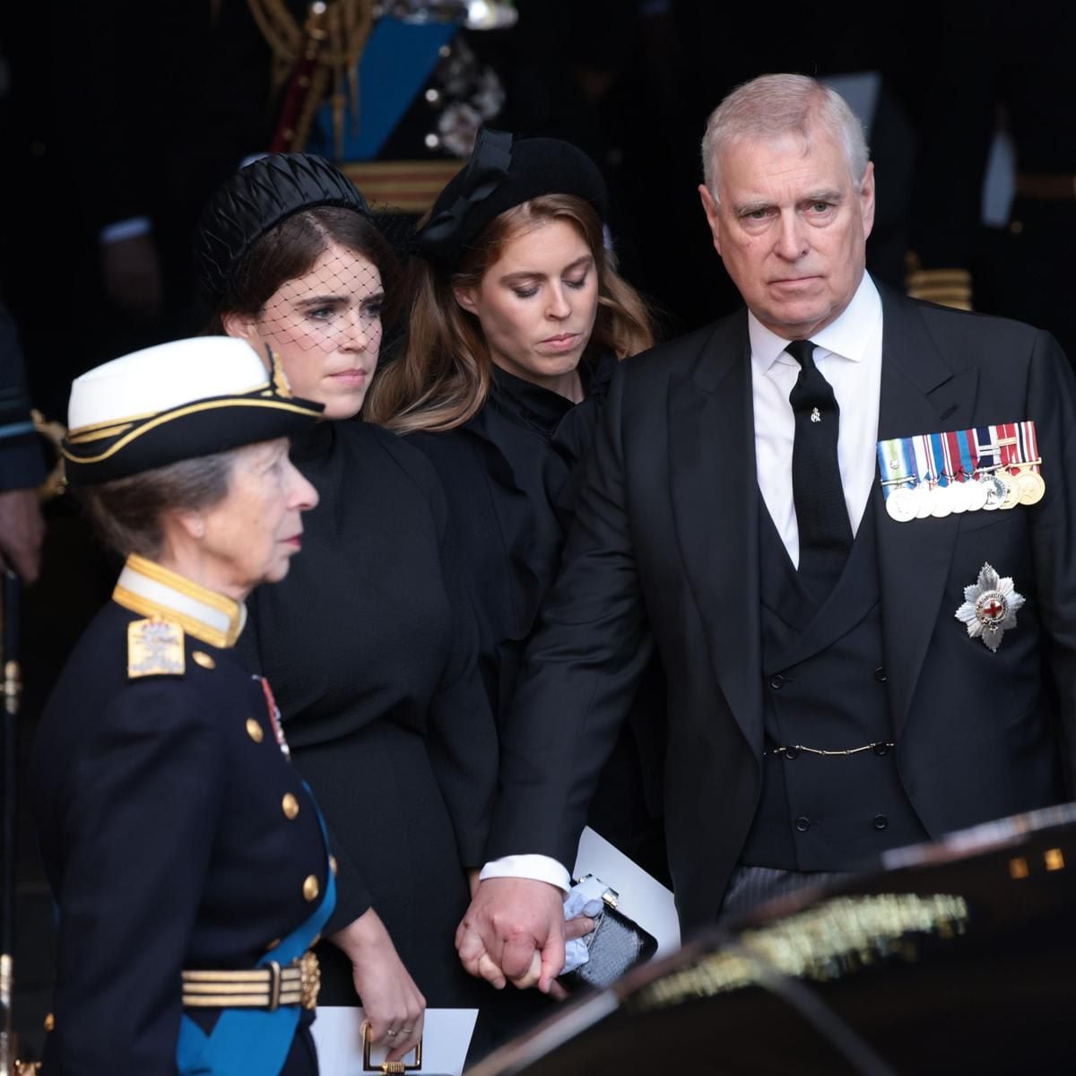 Prince Andrew was seen holding hands with his daughters Eugenie and Beatrice.