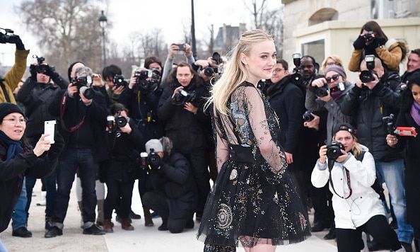 Actress Dakota Fanning turned heads and made bulbs flash arriving at the Valentino fashion show.
<br>
Photo: GC Images