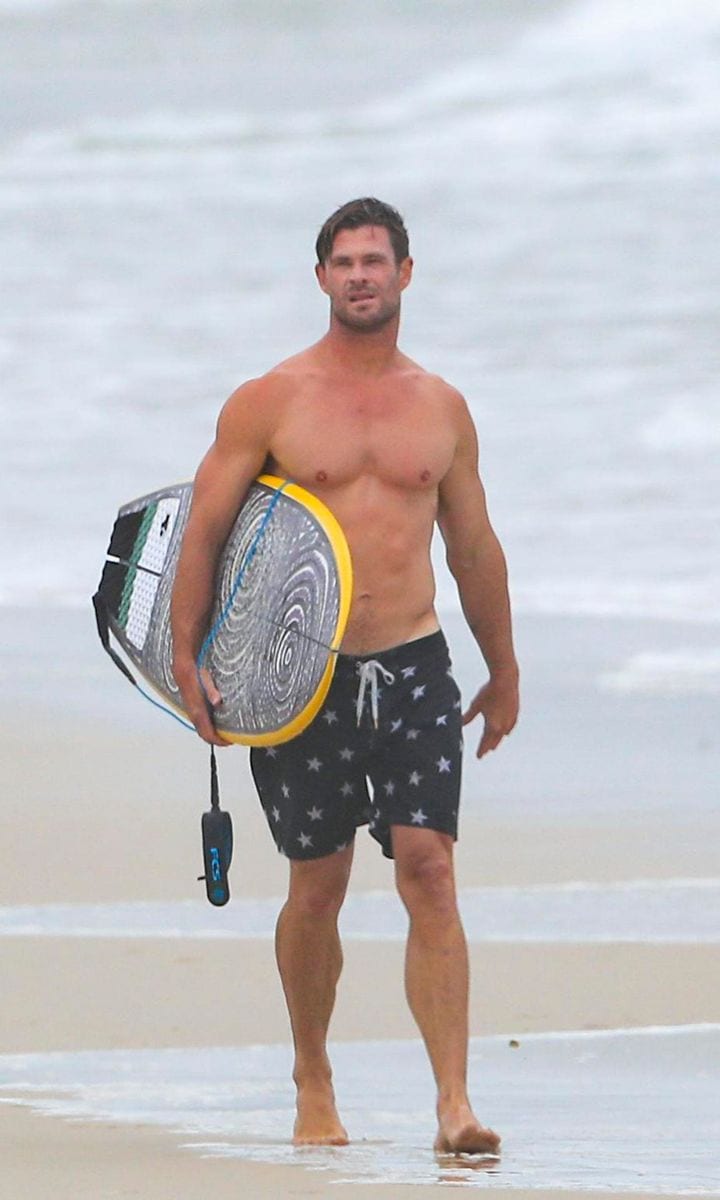 Chris Hemsworth flaunts his muscular physique while surfing