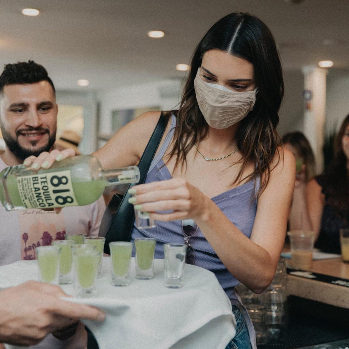 Kendall Jenner is officially a bartender! The businesswoman served her 818 Tequila to fans while visiting the Hamptons