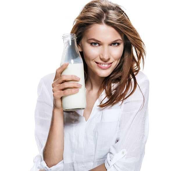 Woman holding a milk bottle