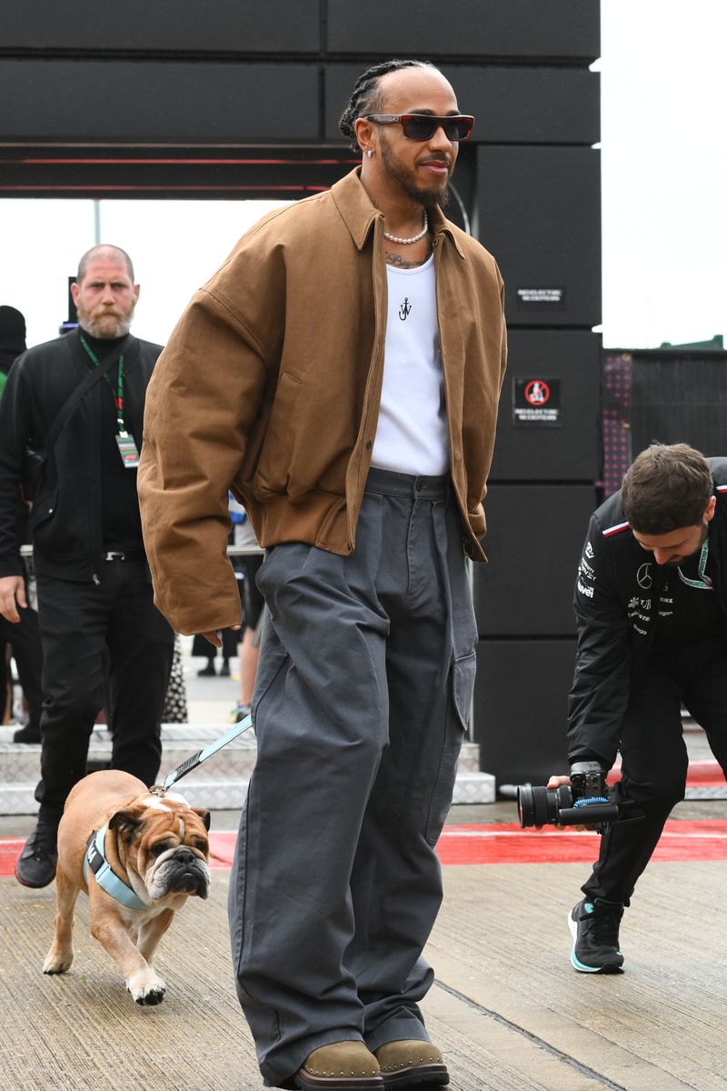 Lewis Hamilton of Great Britain and Mercedes-AMG Petronas F1 is posing with Roscoe during the Formula 1 Qatar Airways British Grand Prix at the Silverstone Circuit in Towcester, England, on Friday, July 5, 2024. 