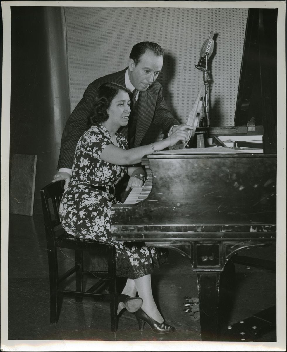 Composer Clotilde Arias showcasing her work at the piano with Argentine Composer and Conductor Terrig Tucci, 1942. Photo credit: national museum of american history, from the Not Lost in Translation: The Life of Clotilde Arias Exhibition. 