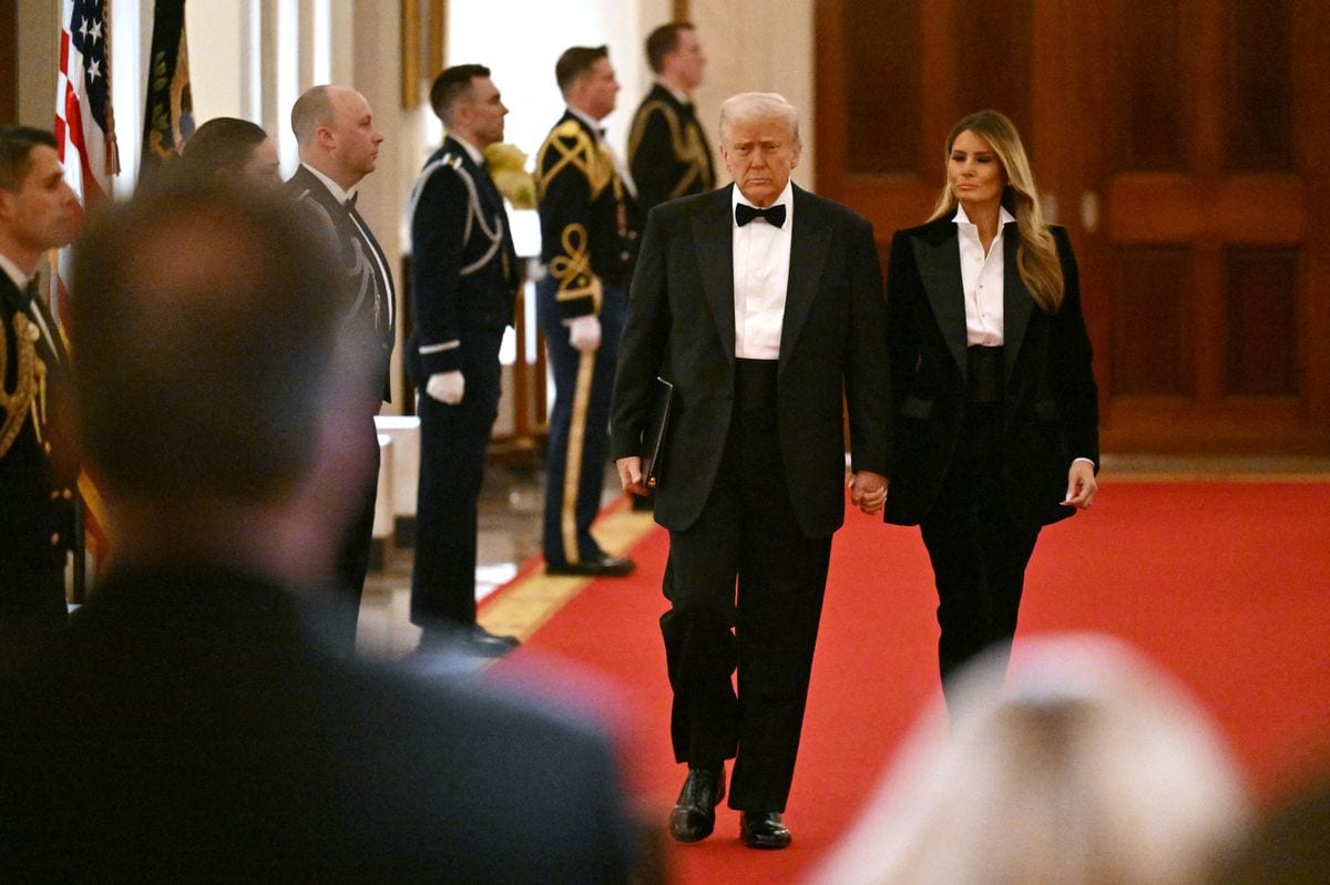 US President Donald Trump and US First Lady Melania Trump arrive for the National Governors Association Evening Dinner and Reception in the East Room of the White House in Washington, DC, on February 22, 2025. 