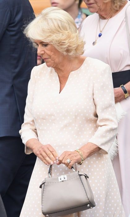 The Duchess of Cornwall had the perfect ensemble for her day at Wimbledon, watching Novak Djokovic play Japan's Kei Nishikori during the men's singles quarter-finals. Prince Charles' wife wore a blush quarter-sleeved dress with polka-dots. She accessorized with a gray Fendi peekaboo tote.
Photo: Getty Images