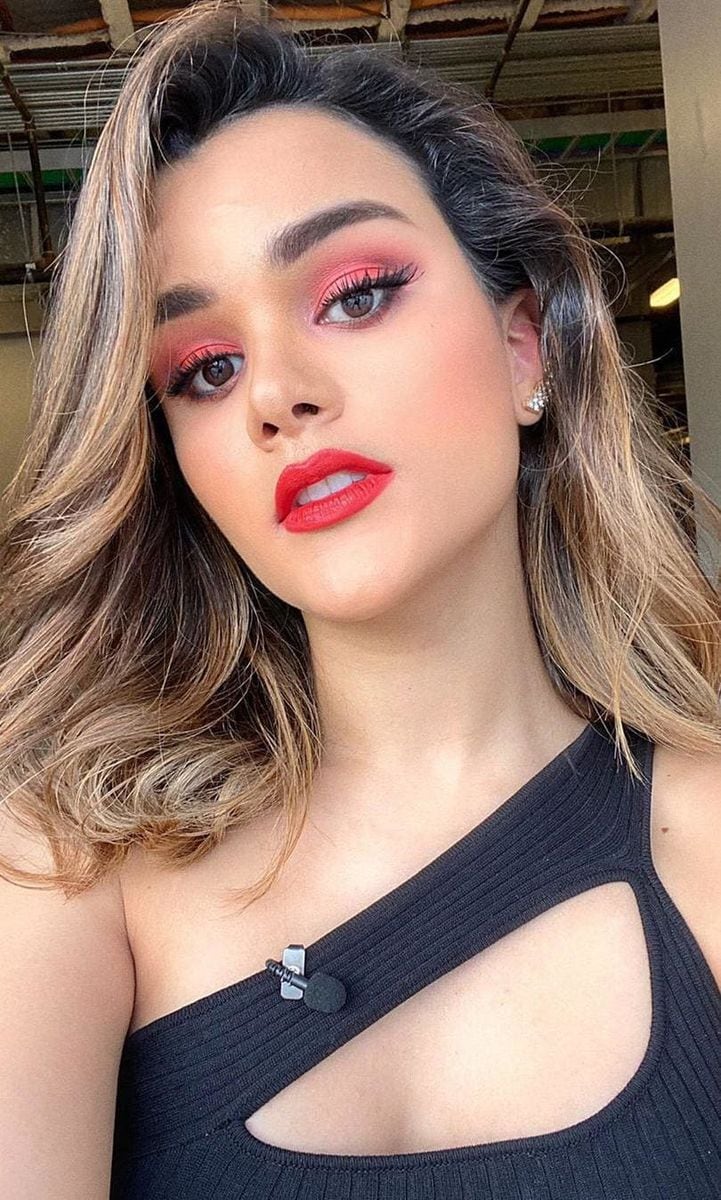 Clarissa Molina with her red, orange, and pink-toned makeup