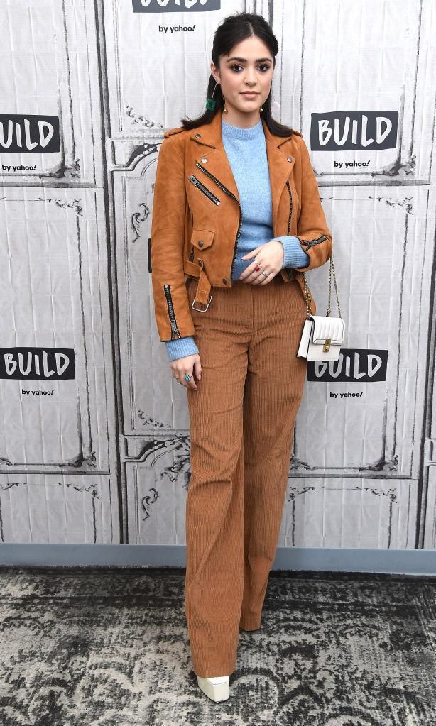 Luna Blaise in a suede jacket, wide leg pants, and platforms