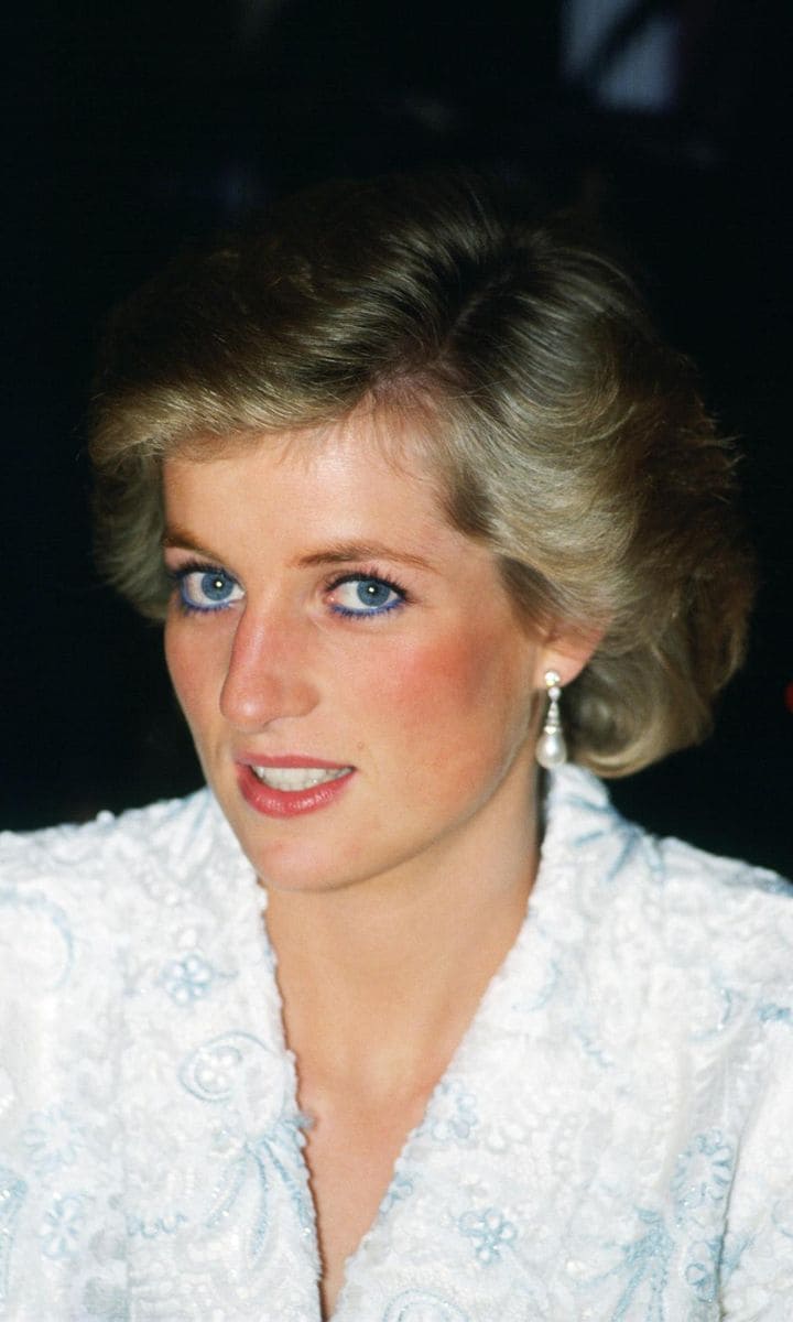 Diana, Princess of Wales wears a white and blue lace and seq