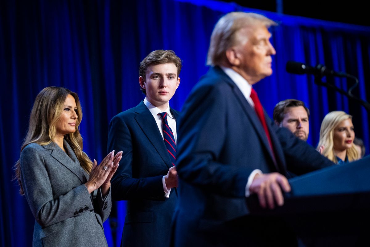 Melania Trump and son Barron Trump listen as president Donald Trump walks out on stage