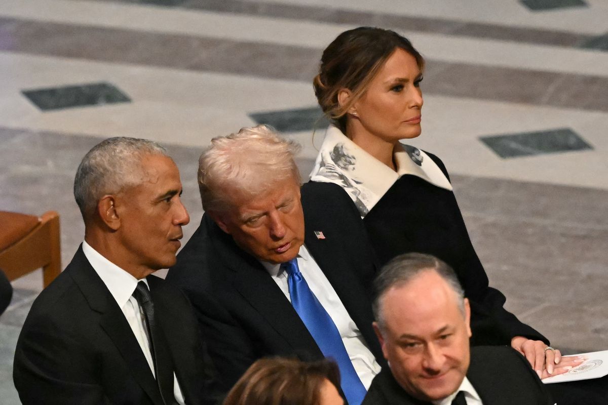 Donald Trump speaks with former President Barack Obama as Melania Trump looks on during the State Funeral Service for former US President Jimmy Carter 