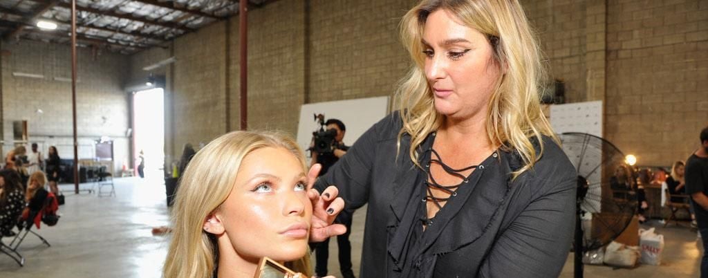 Makeup artist with a model adding foundation