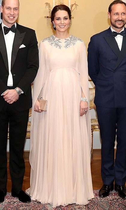 <B>DAY THREE - OSLO, NORWAY</B>
The pregnant Duchess was ethereal in an Alexander McQueen gown with metallic embroidery as she joined Prince William and the Norwegian royal family for a black tie dinner at the royal palace. Kate opted to wear her long brunette hair up in a perfectly styled chignon, and accessorized with a diamond bracelet that was a wedding gift from Queen Elizabeth, along with Her Majesty's pendant earrings. Duchess Kate completed the sophisticated look with a Jimmy Choo clutch.
Photo: WENN