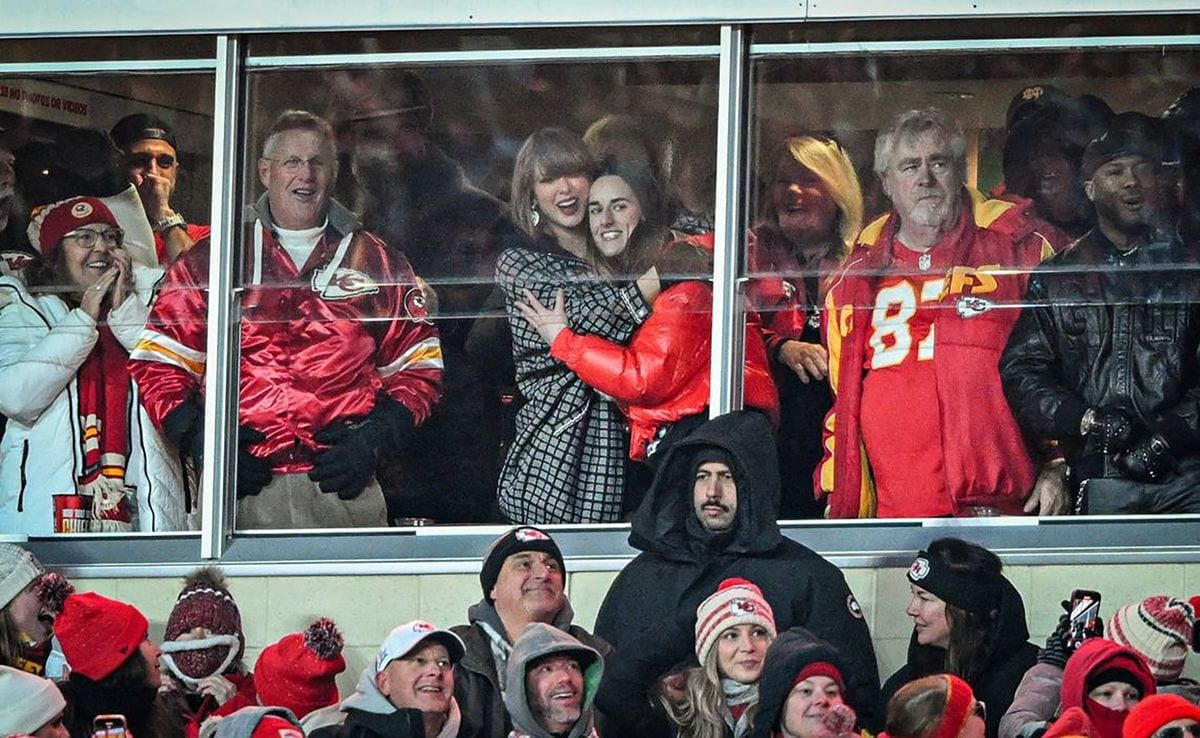 Taylor Swift and Caitlin Clark embrace after Kansas City Chiefs tight end Travis Kelce scored a touchdown in the fourth quarter against the Houston Texans during a AFC Divisional Round playoff game on Jan. 18, 2025, at GEHA Field at Arrowhead Stadium in Kansas City, Missouri. (Emily Curiel/The Kansas City Star/Tribune News Service via Getty Images)