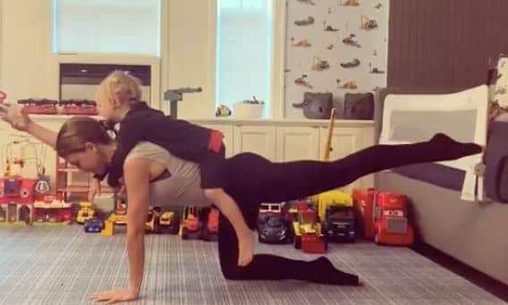 Hilaria Baldwin doing yoga with her son