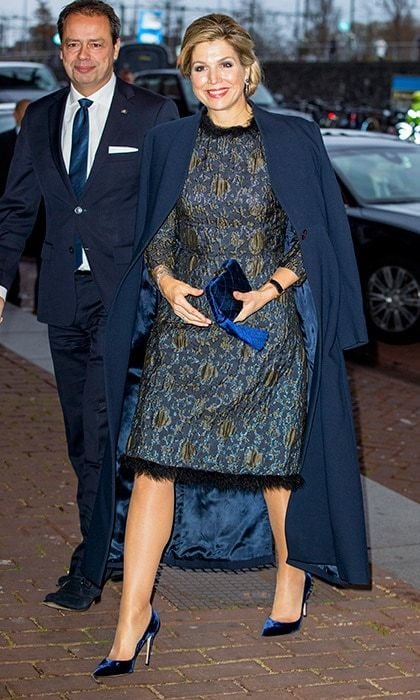 Queen Maxima of the Netherlands never fails to add a fun twist to her outfits. Here, she's wearing a brocade dress trimmed with feathers accessorized with royal blue velvet shoes and clutch for a playful mix of textures. The Dutch royal made the style statement at the Prince Bernhard Culture Foundation Awards in Amsterdam on November 27.
Photo: Patrick van Katwijk/Getty Images