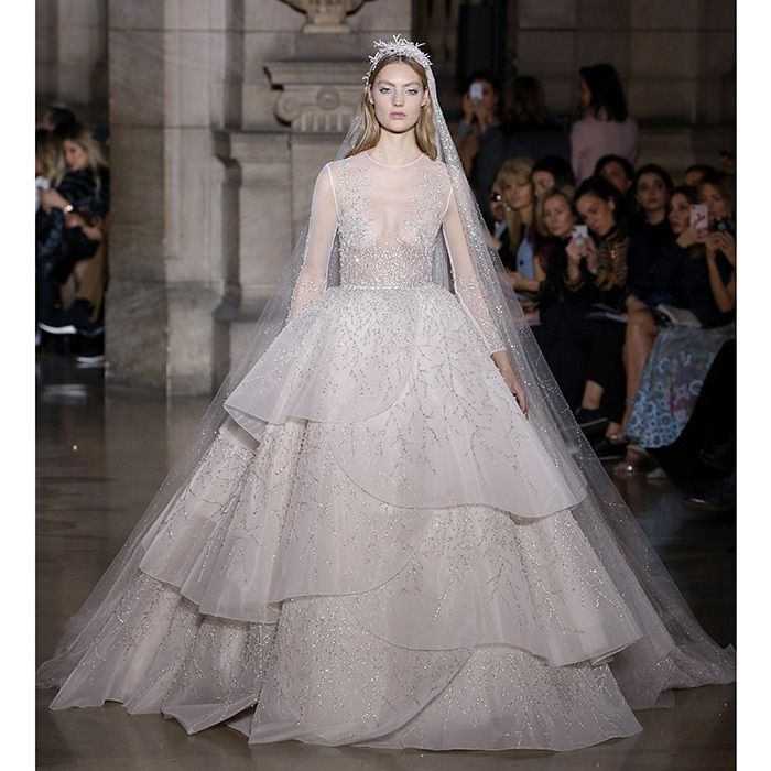 <b>GEORGES HOBEIKA</B>
The finale gown of a collection inspired by ancient Greece was this long-sleeve illusion bodice gown with gorgeous tiered skirt and sparkling embroidery.
Photo: WENN