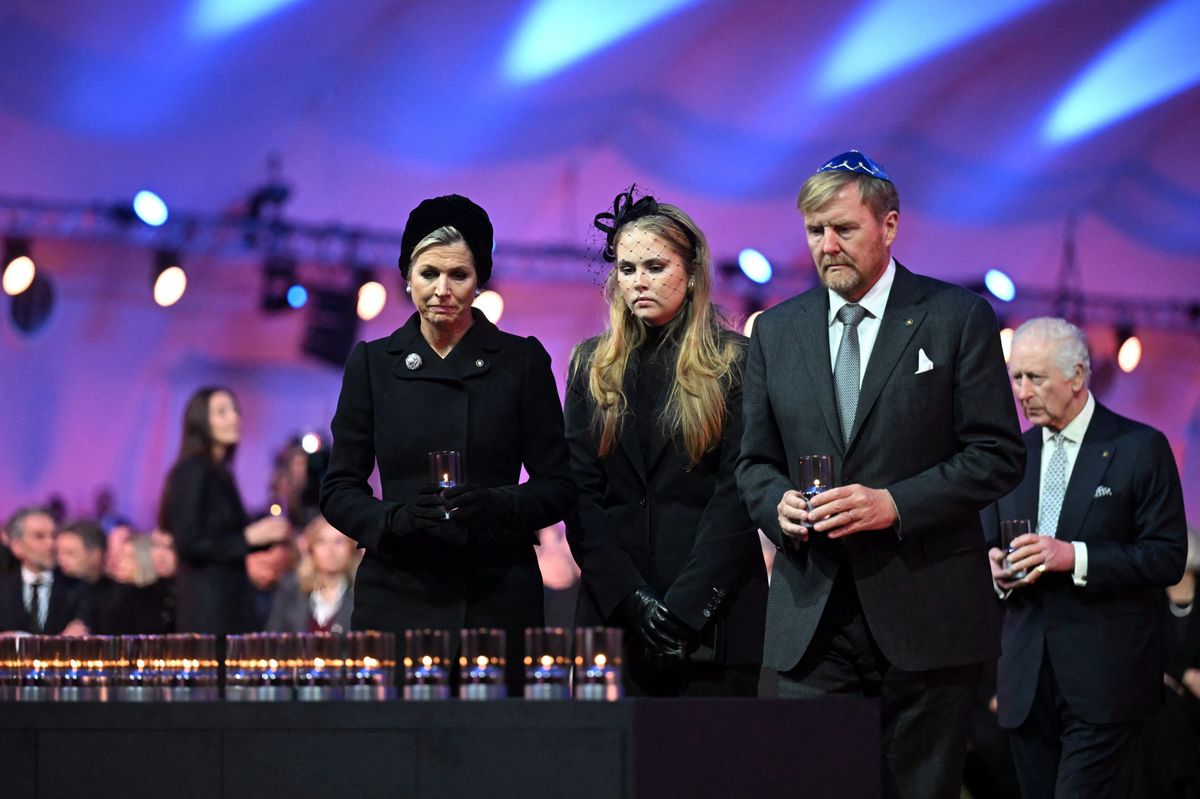 (LtoR) Queen Maxima of the Netherlands, Princess Catharina-Amalia of the Netherlands, Princess of Orange and King Willem-Alexander of the Netherlands and Britain's King Charles III arrive to place votive candles in front of the train car, the symbol of the event, to pay tribute to the victims during commemorations on the 80th anniversary of the liberation of the German Nazi concentration and extermination camp Auschwitz-Birkenau by the Red Army, in Oswiecim, Poland on January 27, 2025. (Photo by Sergei GAPON / AFP) (Photo by SERGEI GAPON/AFP via Getty Images)