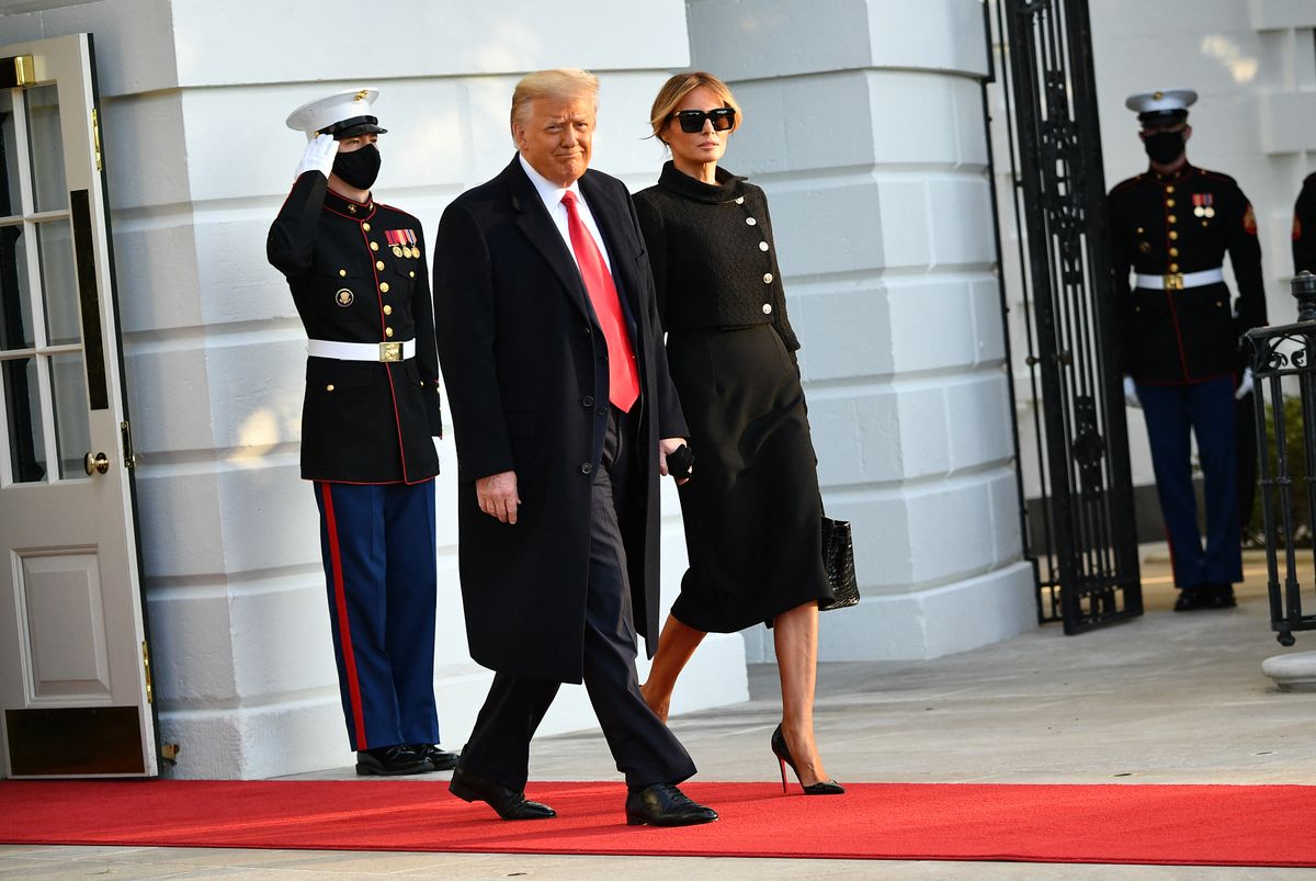 TOPSHOT - US President Donald Trump and First Lady Melania make their way to board Marine One before departing from the South Lawn of the White House in Washington, DC on January 20, 2021. President Trump travels his Mar-a-Lago golf club residence in Palm Beach, Florida, and will not attend the inauguration for President-elect Joe Biden. (Photo by MANDEL NGAN / AFP) (Photo by MANDEL NGAN/AFP via Getty Images)