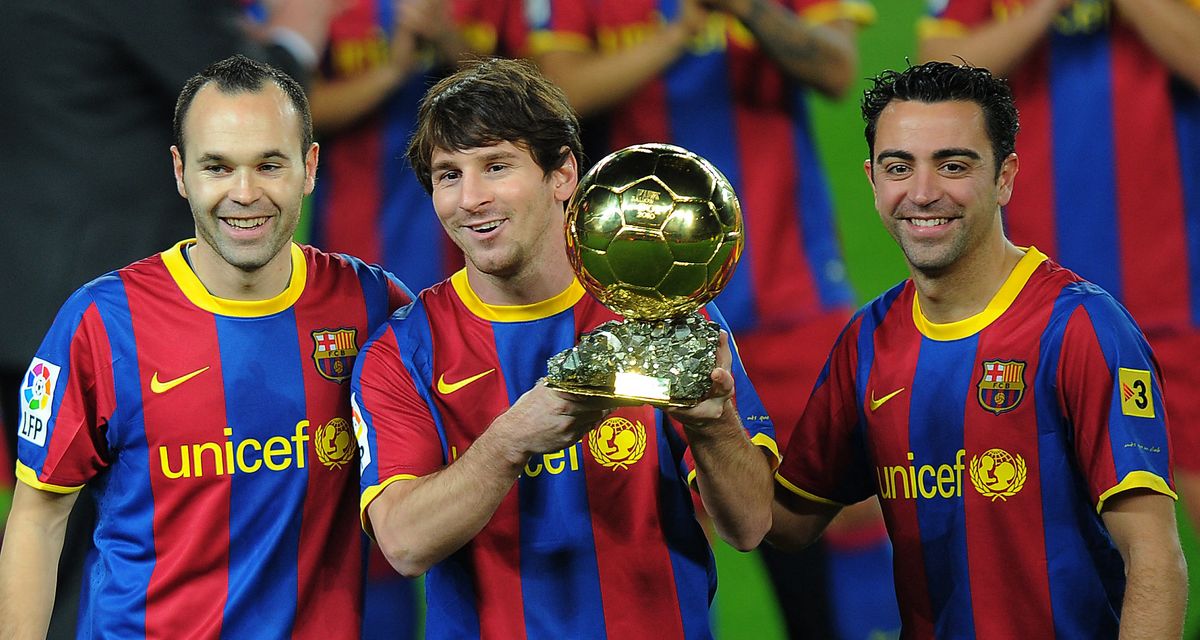 Lionel Messi with Barcelona's midfielder Xavi Hernandez and Barcelona's midfielder Andres Iniesta posing with the 2010 Ballon d'Or trophy (Golden Ball) for the best European footballer of the year prior to the Copa del Rey (King's Cup) football match FC Barcelona vs Real Betis on January 12, 2011 