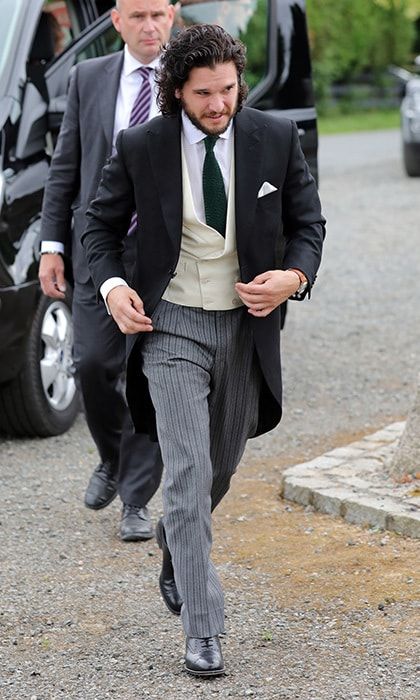 The groom arrived for his walk down the aisle looking handsome in a morning suit with black jacket, cream waistcoat, and grey striped trousers.
Photo: Getty Images