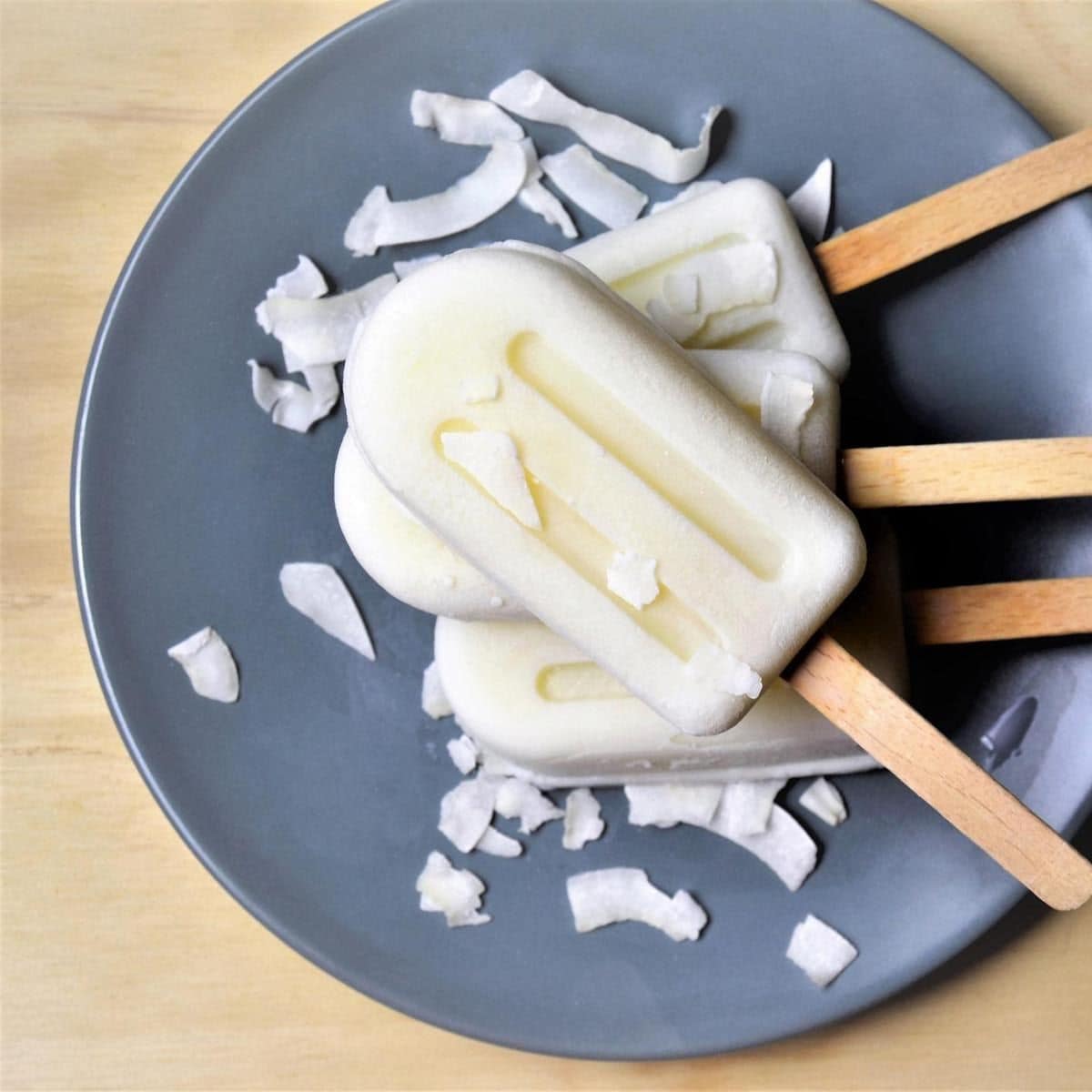 Coconut yogurt popsicles on a table, top view