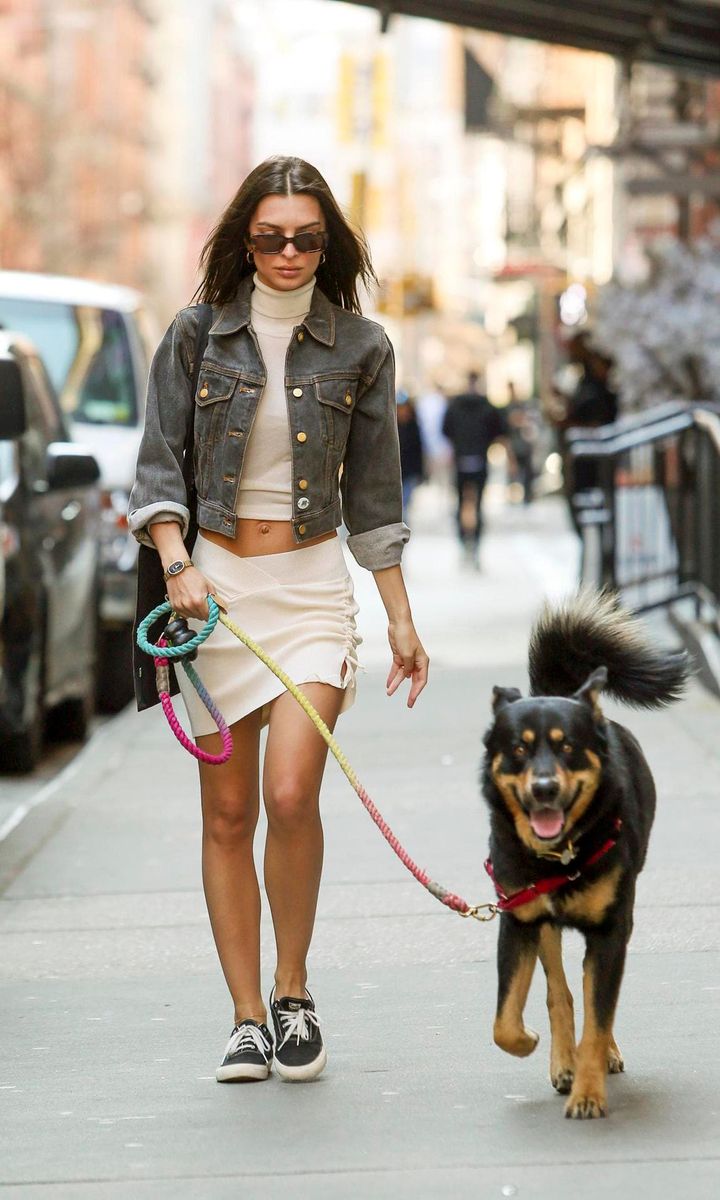 Emily Ratajkowski Stuns In A Denim Jacket, White Mini Skirt And Sneakers In NYC