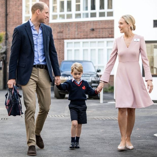 George held hands with his father and the school official as he made his way inside for his first day at Thomas's Battersea.
Photo: RICHARD POHLE/AFP/Getty Images