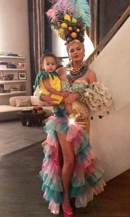 Chrissy Teigen and daughter Luna Legend coordinated this Halloween. The cookbook author fittingly dressed as Carmen Miranda with her and John's baby girl dressing as a pineapple.
Chrissy's hairstylist and friend Jen Atkin shared the photo on Instagram with the caption: "Ms. Miranda and her lil (I'm retiring Kira Kira after this gem) #swipe @chrissyteigen x @1maryphillips #jenatkinhair "
Photo: Instagram/@Jenatkinhair