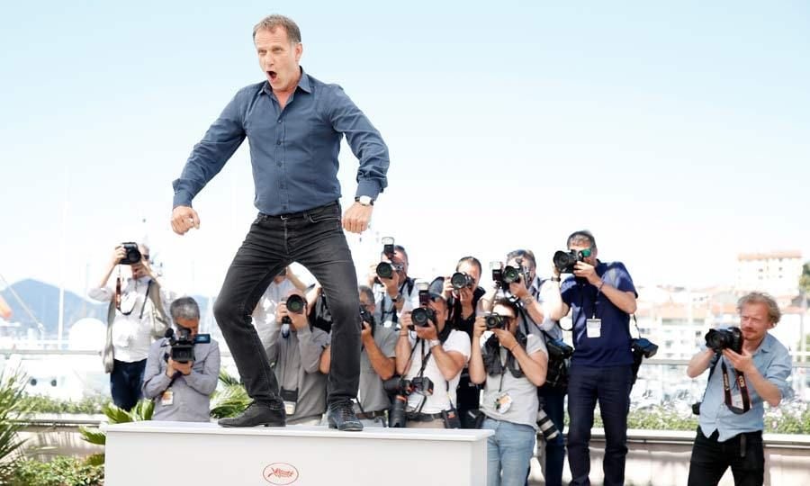 Causing a scene! French actor and director Charles Berling entertained photographers when he climbed up on a table and did he best King Kong impression at the <i>Elle</i> photocall.
<br>Photo: Getty Images