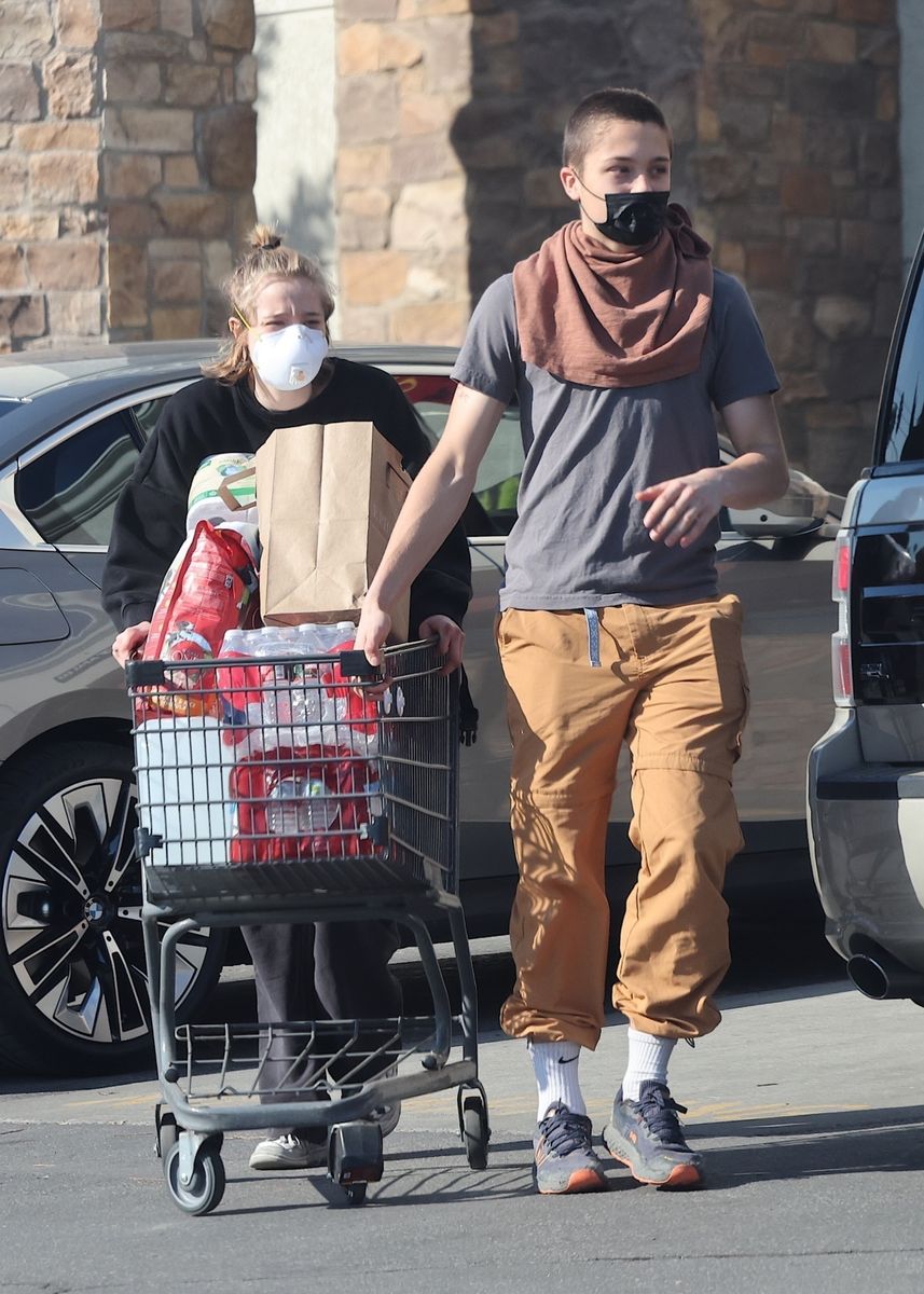 Shiloh and Knox Jolie-Pitt carrying groceries and supplies for the victims of the Los Angeles fires