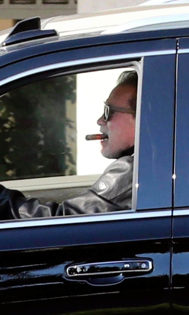 Arnold Schwarzenegger smoking a cigar in the car a few weeks after having heart surgery.