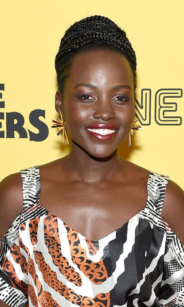 Lupita Nyong'o with a high chignon bun and braidsn