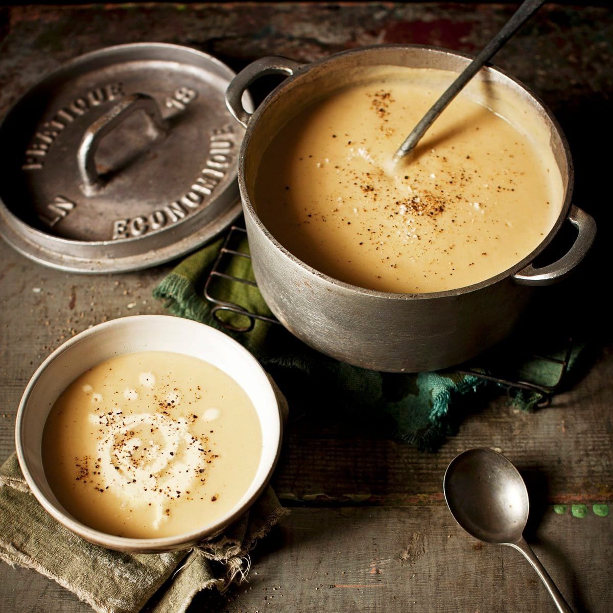 Leek and potato soup in a cast iron pot and in a bowl